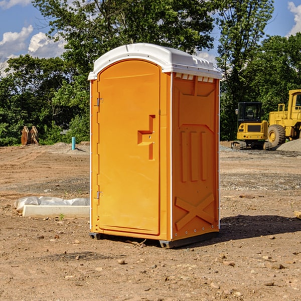 what is the cost difference between standard and deluxe portable toilet rentals in Greenfield Center